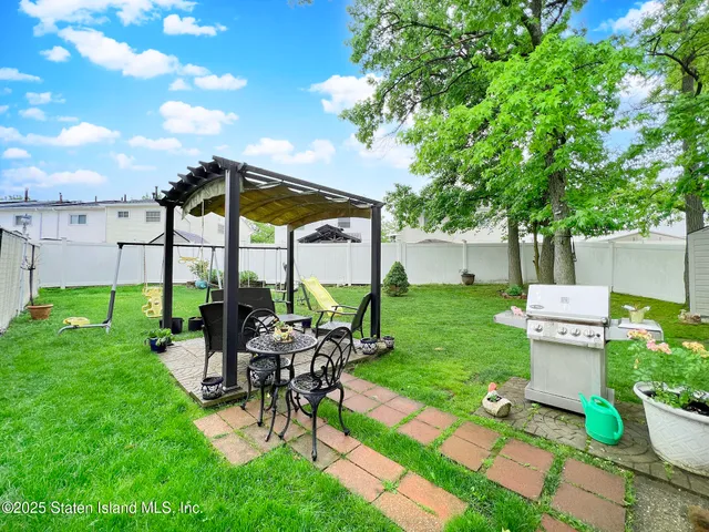 a view of a patio with chairs and plants