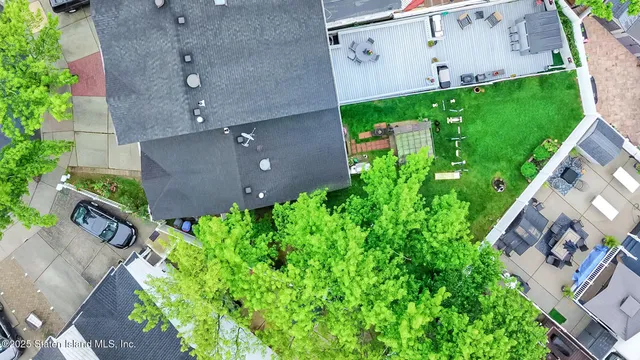 an aerial view of a house with a backyard space