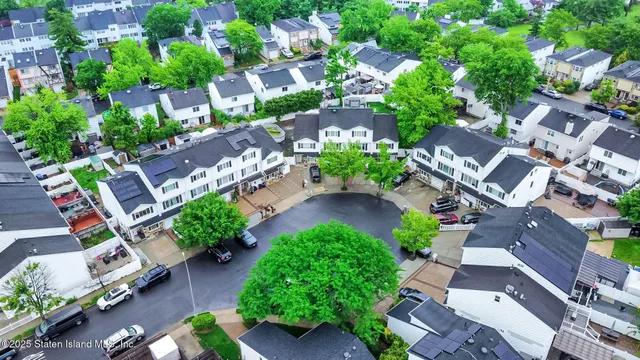 an aerial view of multiple houses with yard