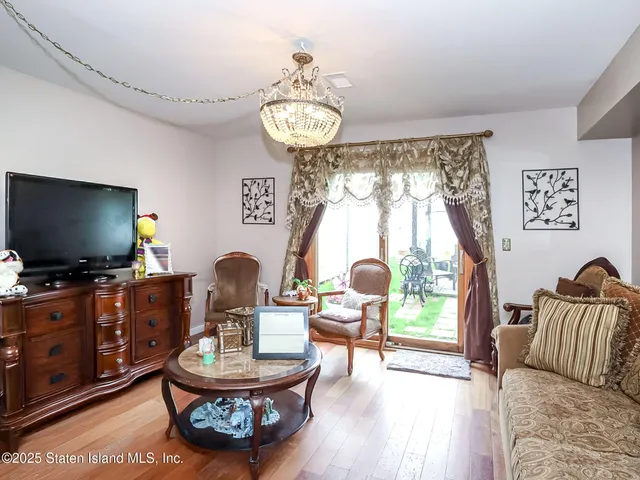 a living room with furniture a window and a flat screen tv