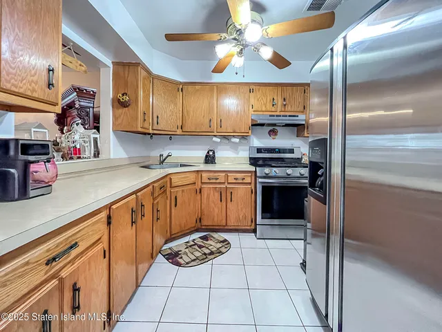 a kitchen with stainless steel appliances a sink and a refrigerator