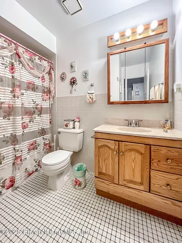 a bathroom with a granite countertop toilet sink and mirror