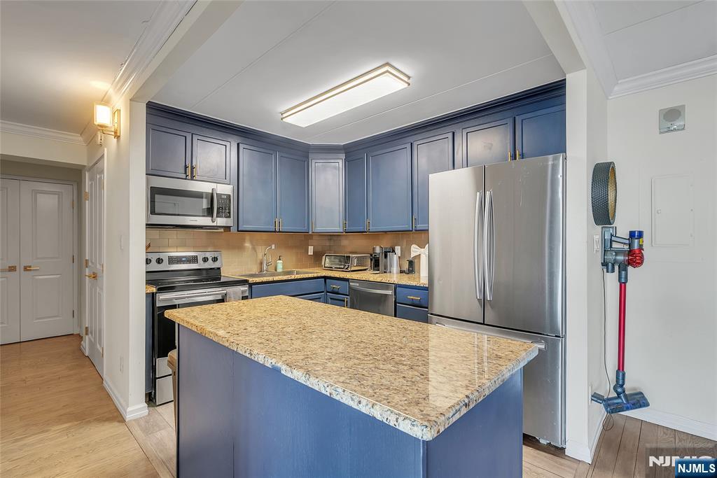 250 Gorge Road, Unit 21B Cliffside Park, NJ 07010 - Photo 11 of 37 a kitchen with stainless steel appliances granite countertop a refrigerator and a stove