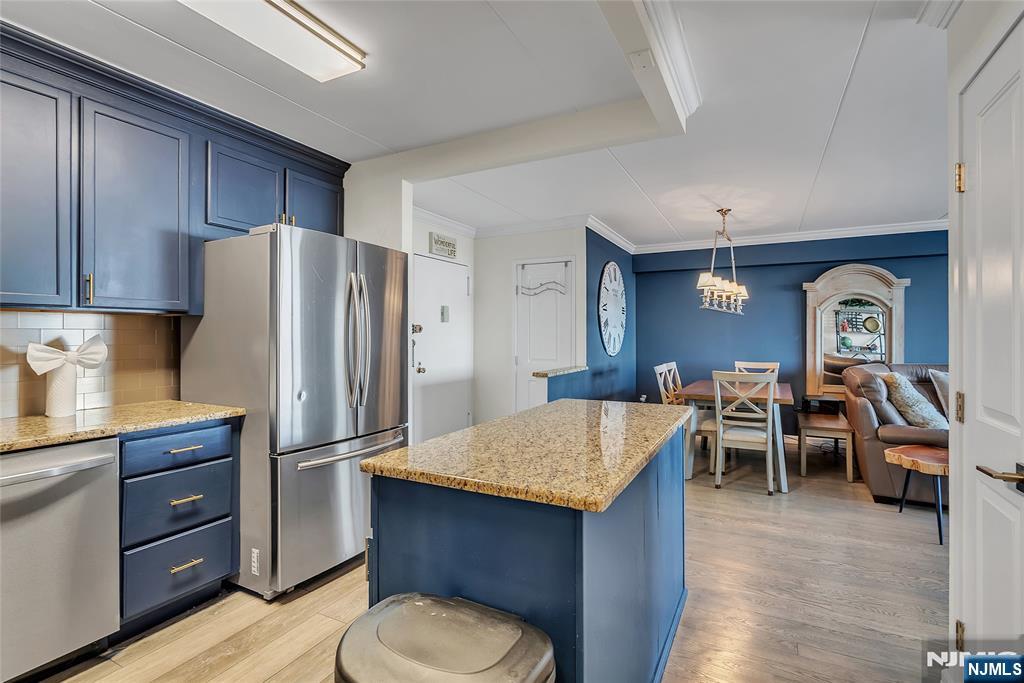 250 Gorge Road, Unit 21B Cliffside Park, NJ 07010 - Photo 12 of 37 a kitchen with stainless steel appliances granite countertop a refrigerator and a stove