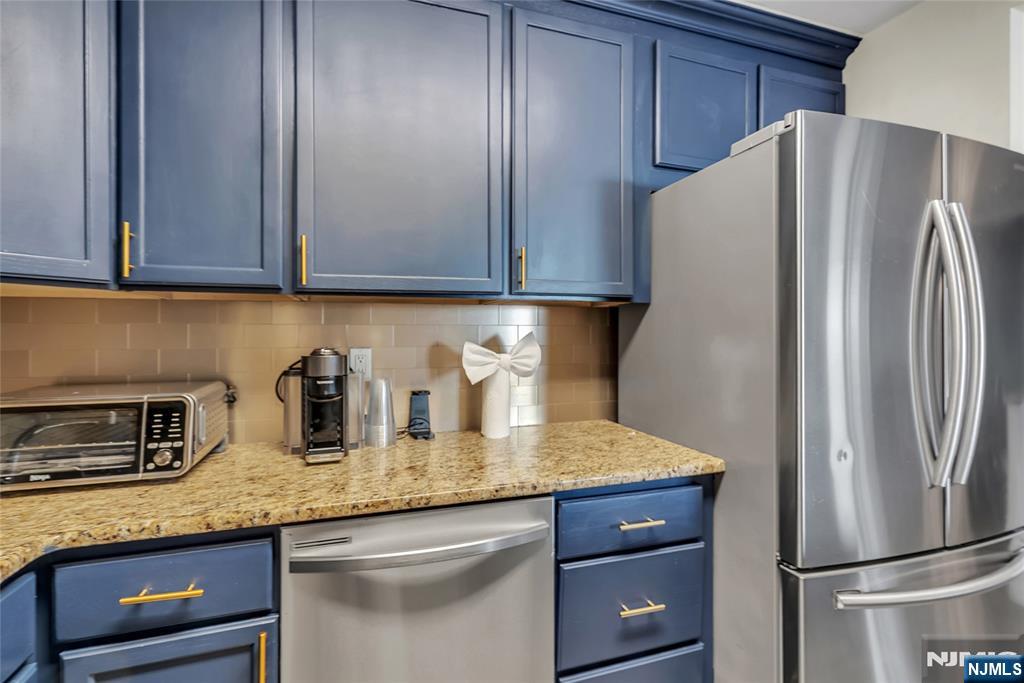 250 Gorge Road, Unit 21B Cliffside Park, NJ 07010 - Photo 13 of 37 a kitchen with stainless steel appliances granite countertop a refrigerator and a sink