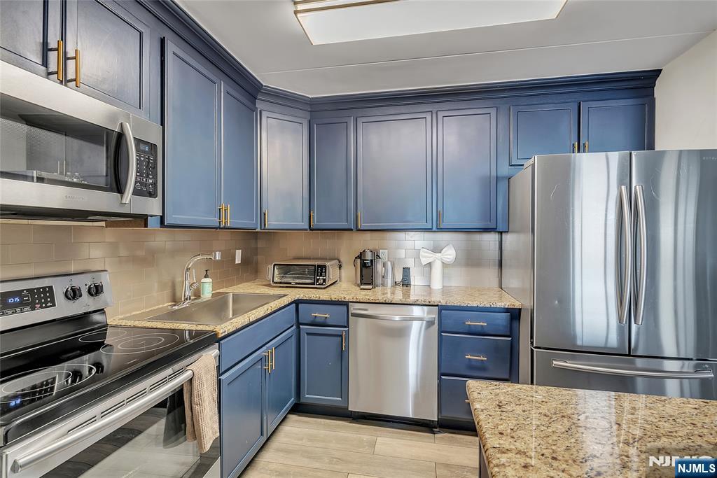 250 Gorge Road, Unit 21B Cliffside Park, NJ 07010 - Photo 15 of 37 a kitchen with stainless steel appliances granite countertop a refrigerator stove and sink