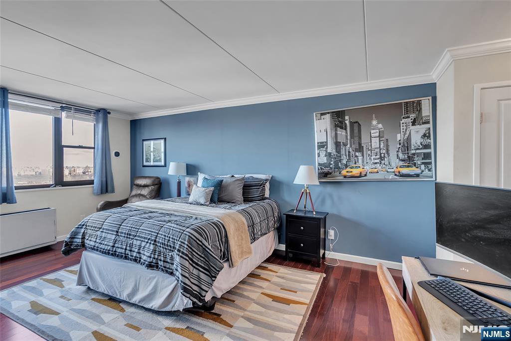 250 Gorge Road, Unit 21B Cliffside Park, NJ 07010 - Photo 21 of 37 a bedroom with a bed and wooden floor