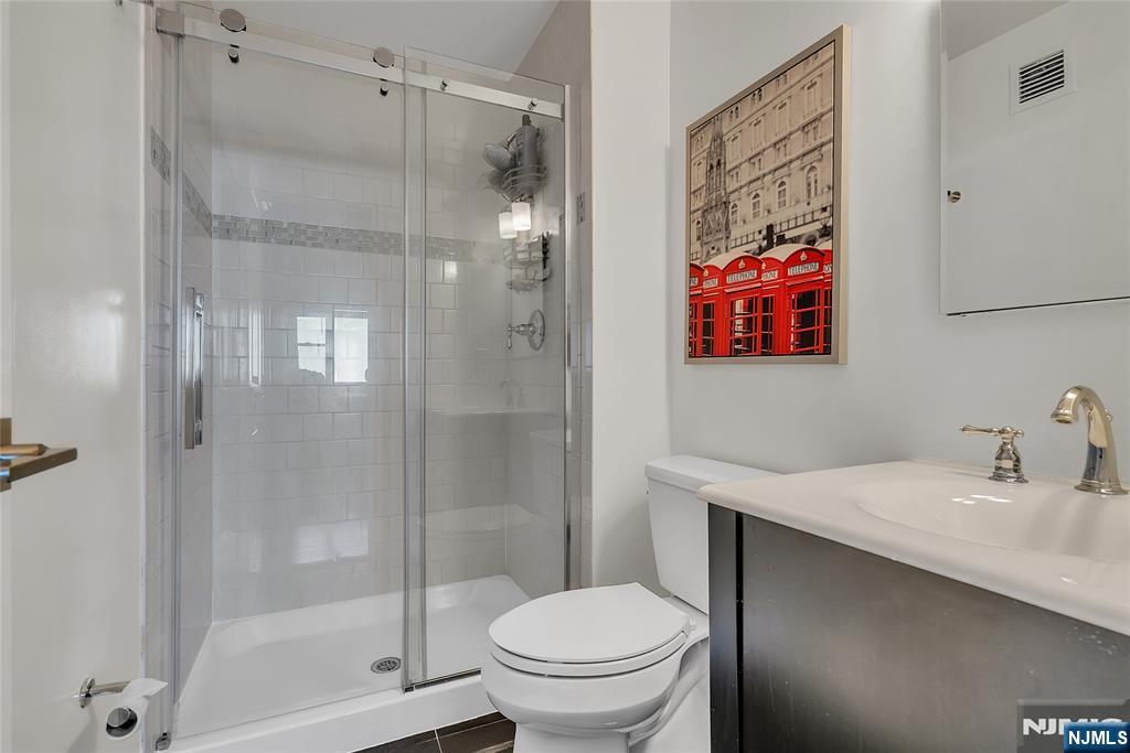 250 Gorge Road, Unit 21B Cliffside Park, NJ 07010 - Photo 23 of 37 a bathroom with a shower a toilet and sink