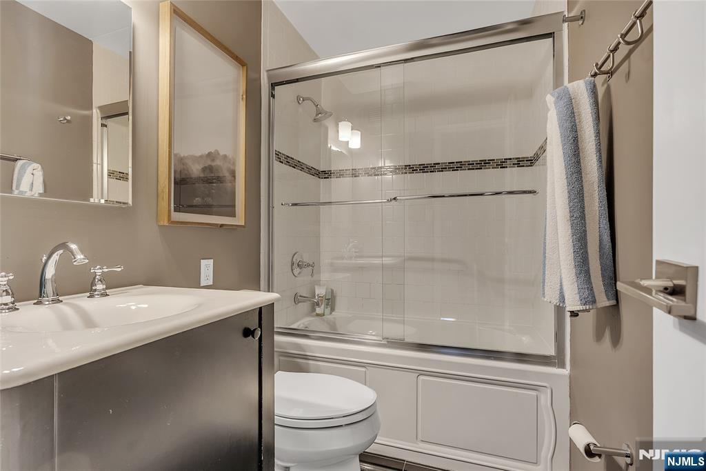 250 Gorge Road, Unit 21B Cliffside Park, NJ 07010 - Photo 26 of 37 a bathroom with a granite countertop sink toilet and shower