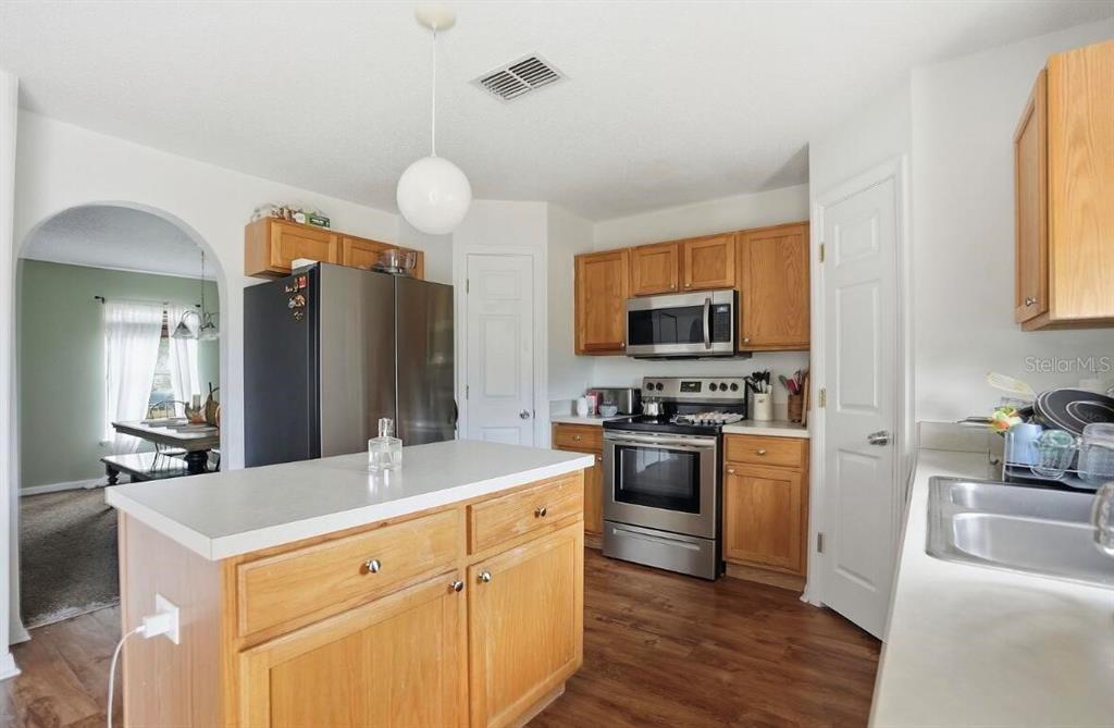 11077 Jenny Wren Road Weeki Wachee, FL 34614 - Photo 11 of 42 a kitchen with a refrigerator stove and sink