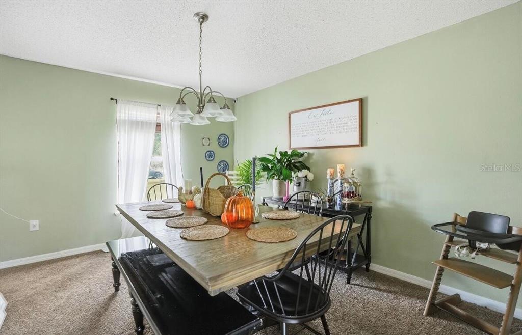 11077 Jenny Wren Road Weeki Wachee, FL 34614 - Photo 16 of 42 a view of a dining room with furniture and chandelier