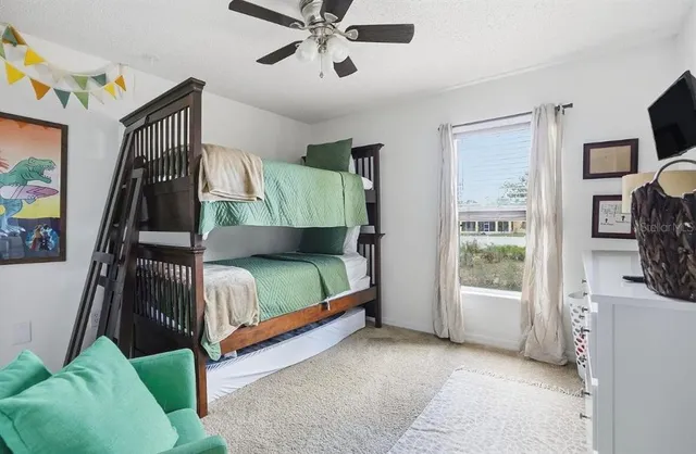 a bedroom with a bed and a flat tv screen