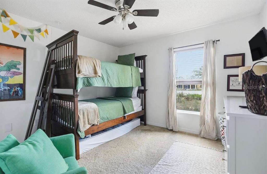 11077 Jenny Wren Road Weeki Wachee, FL 34614 - Photo 24 of 42 a bedroom with a bed and a flat tv screen