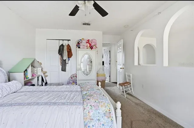 a bedroom with a bed and a large mirror