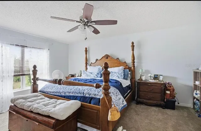 a bedroom with bed and window