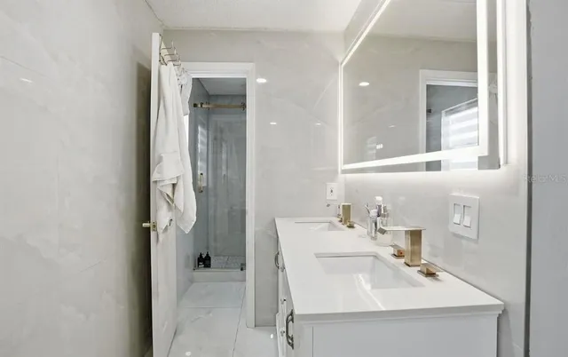 a bathroom with a sink vanity and a mirror