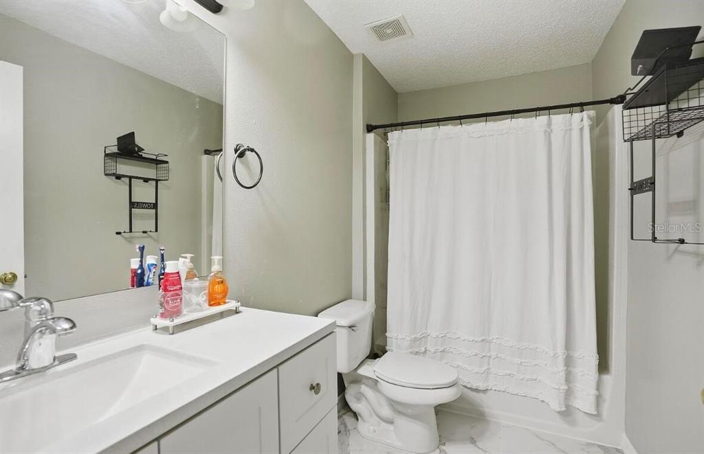 11077 Jenny Wren Road Weeki Wachee, FL 34614 - Photo 33 of 42 a bathroom with a sink vanity mirror and toilet