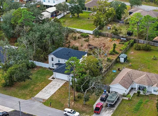an aerial view of a house with a yard