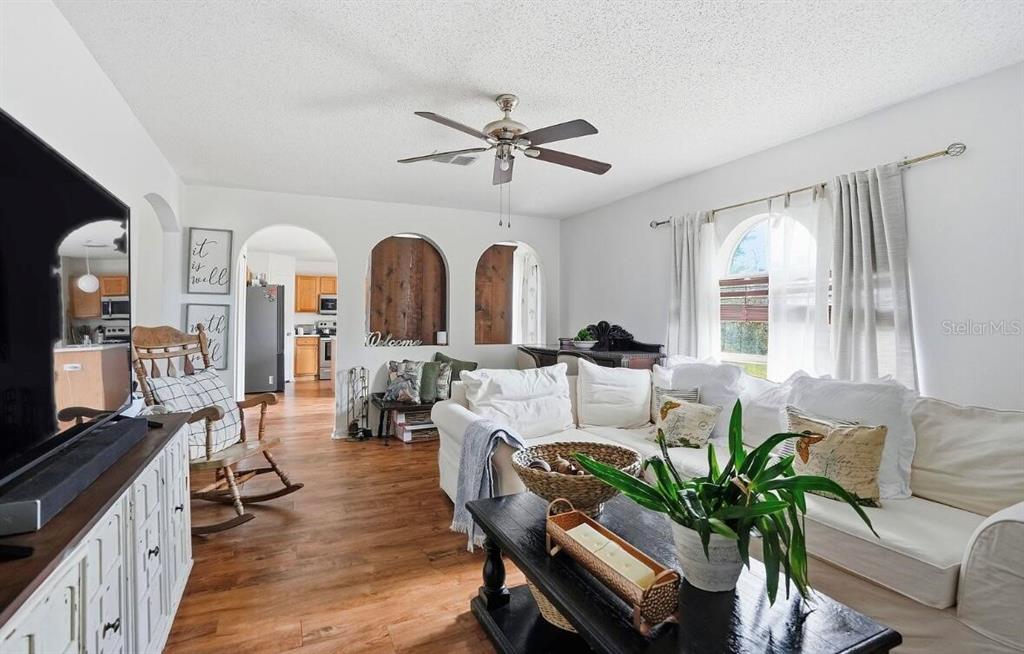 11077 Jenny Wren Road Weeki Wachee, FL 34614 - Photo 8 of 42 a living room with fireplace furniture and a large window