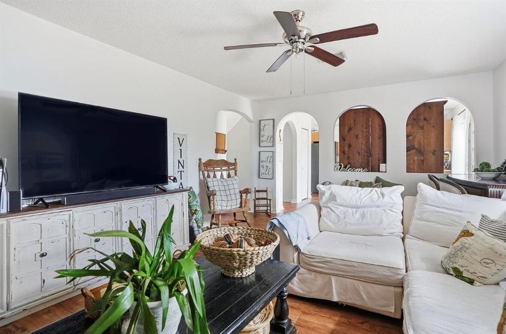 11077 Jenny Wren Road Weeki Wachee, FL 34614 - Photo 9 of 42 a living room with furniture and a flat screen tv