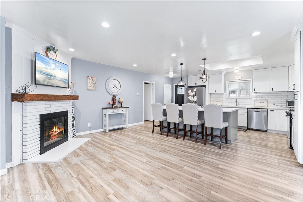 7932 Euclid Avenue Whittier, CA 90602 - Photo 11 of 31 a living room with furniture and a fireplace with wooden floor