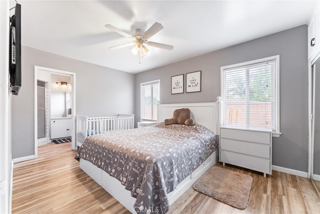 7932 Euclid Avenue Whittier, CA 90602 - Photo 18 of 31 a spacious bedroom with a bed and a chandelier