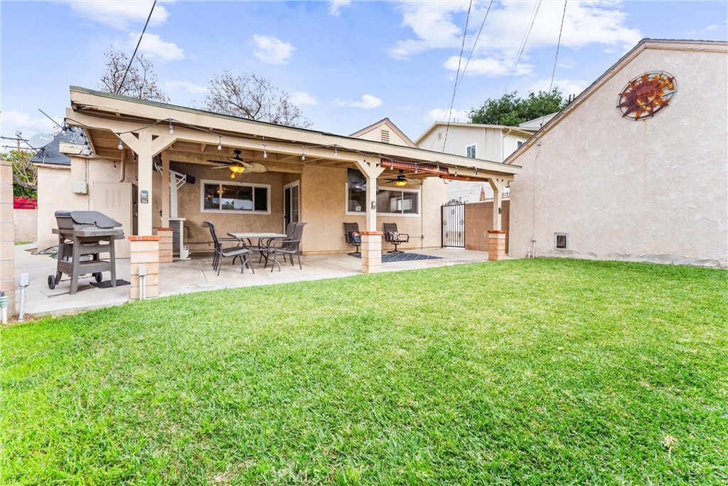 7932 Euclid Avenue Whittier, CA 90602 - Photo 28 of 31 a view of a patio with table and chairs with wooden fence