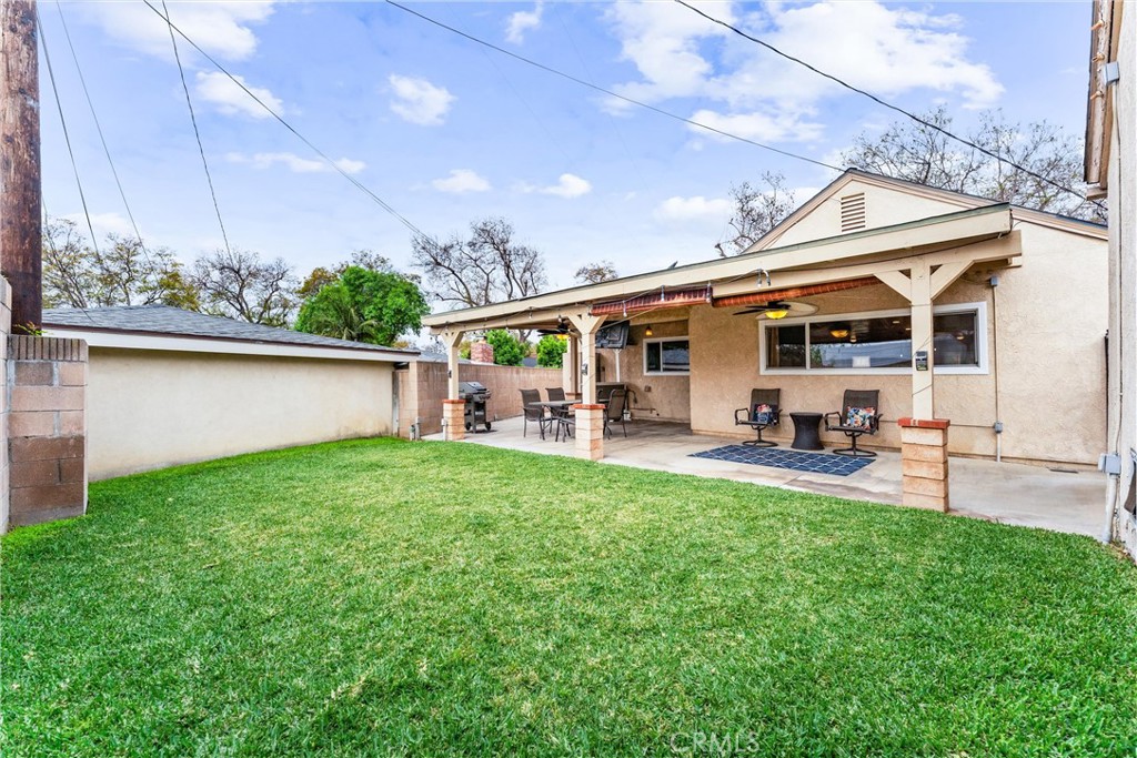 7932 Euclid Avenue Whittier, CA 90602 - Photo 29 of 31 a view of a patio with table and chairs potted plants with wooden floor