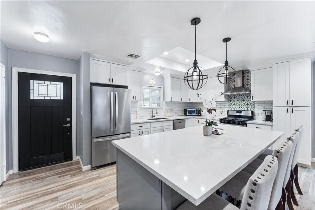 7932 Euclid Avenue Whittier, CA 90602 - Photo 6 of 31 a kitchen with stainless steel appliances granite countertop a sink a stove and refrigerator