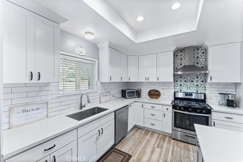 7932 Euclid Avenue Whittier, CA 90602 - Photo 10 of 31 a kitchen with a sink white cabinets and white appliances