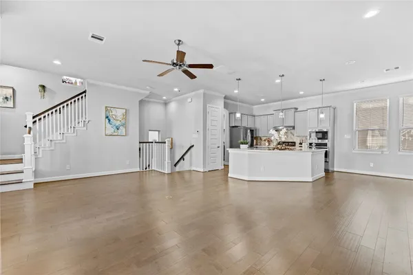 a view of a kitchen with furniture and wooden floor