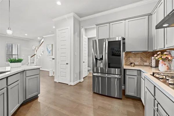 a kitchen with stainless steel appliances a refrigerator and a stove