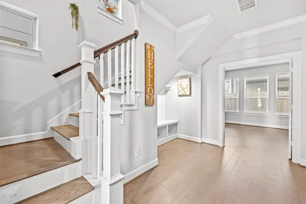 a view of entryway and hall with wooden floor