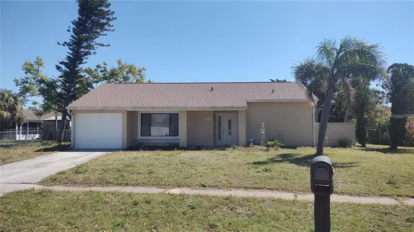 a view of a house with a yard covered in snow