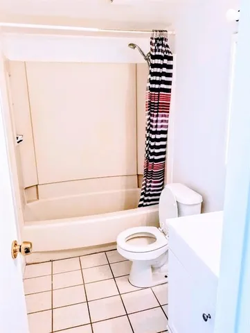 a bathroom with a toilet a sink and a mirror