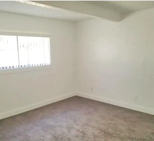 a view of an empty room and a window