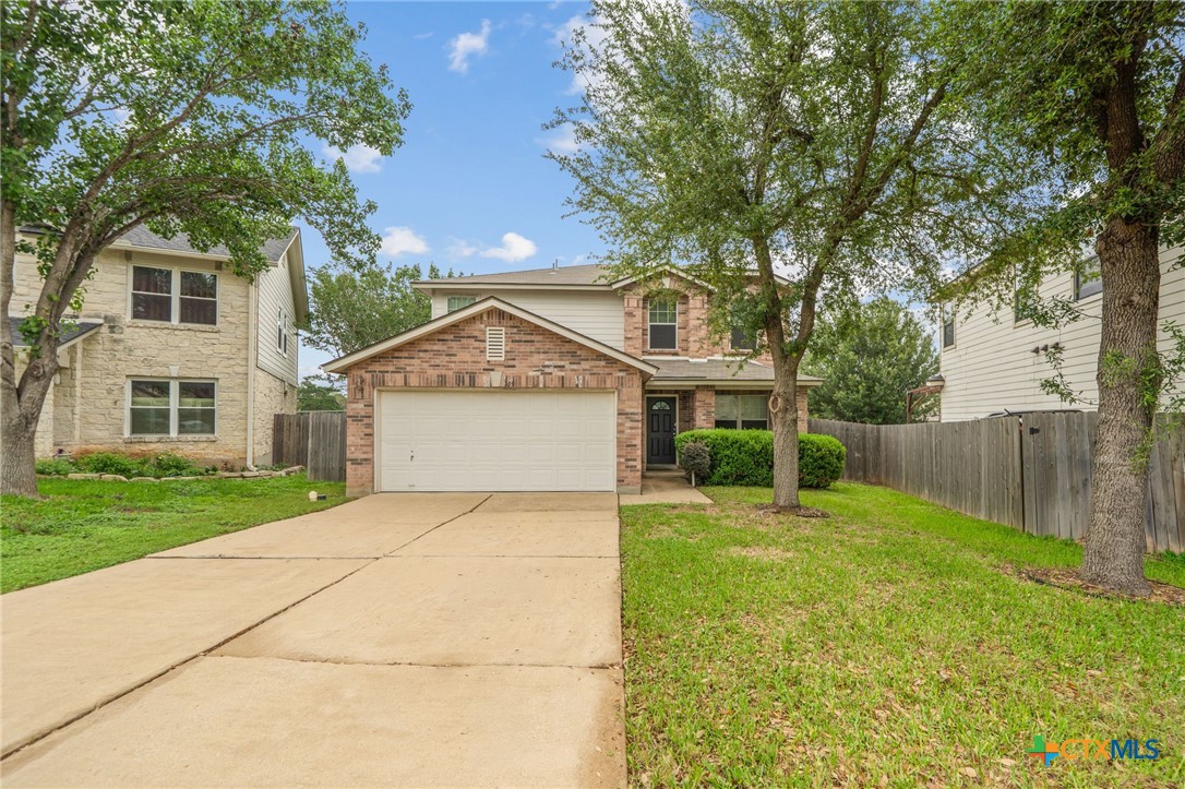 109 Comal Cove Elgin, TX 78621 - Photo 1 of 34 front view of a house with a yard