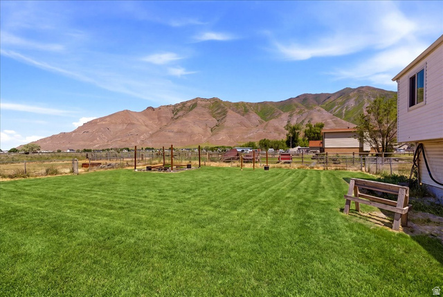 1613 Sunset Road Lake Point, UT 84074 - Photo 28 of 33 Expansive green lawn with mountain backdrop