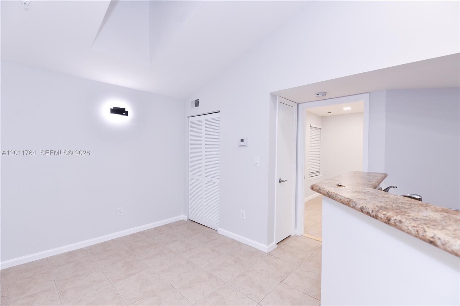 1011 Crystal Way, Unit D Delray Beach, FL 33444 - Photo 3 of 9 a bathroom with a granite countertop sink and a mirror