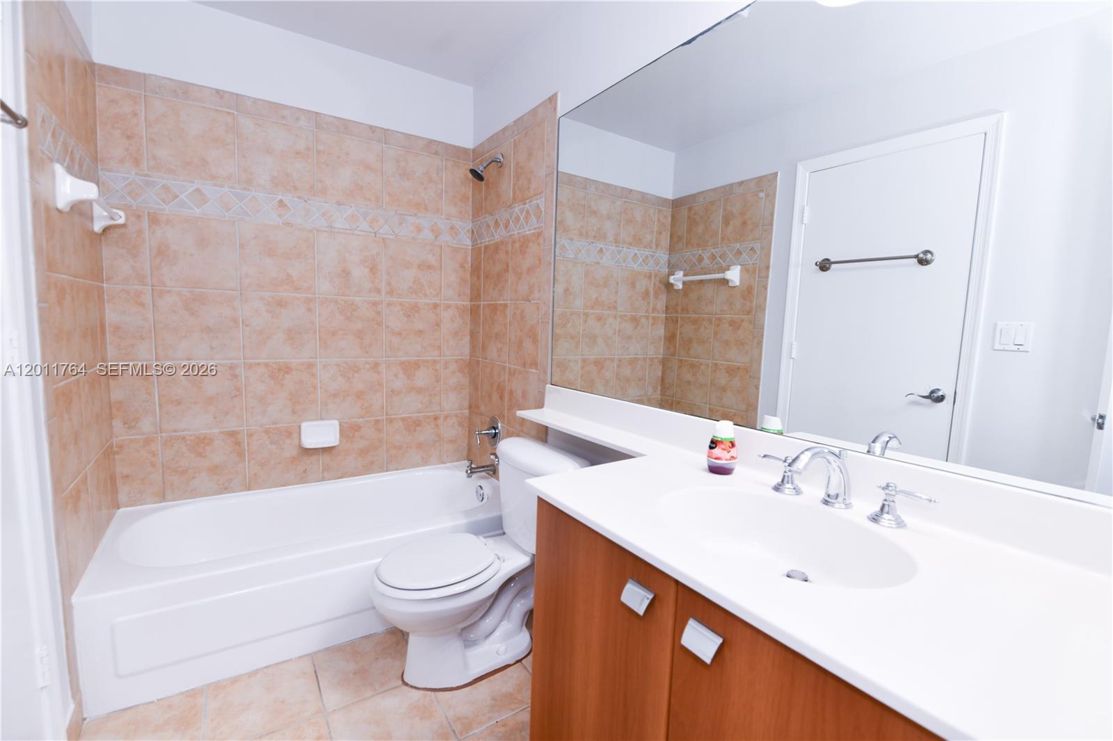 1011 Crystal Way, Unit D Delray Beach, FL 33444 - Photo 5 of 9 a bathroom with a bathtub shower sink mirror and toilet