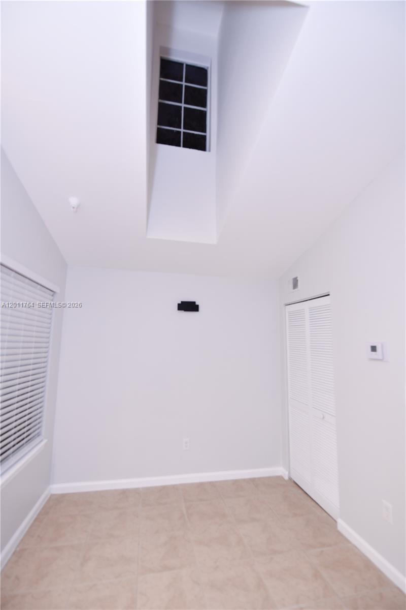1011 Crystal Way, Unit D Delray Beach, FL 33444 - Photo 9 of 9 an empty room with windows