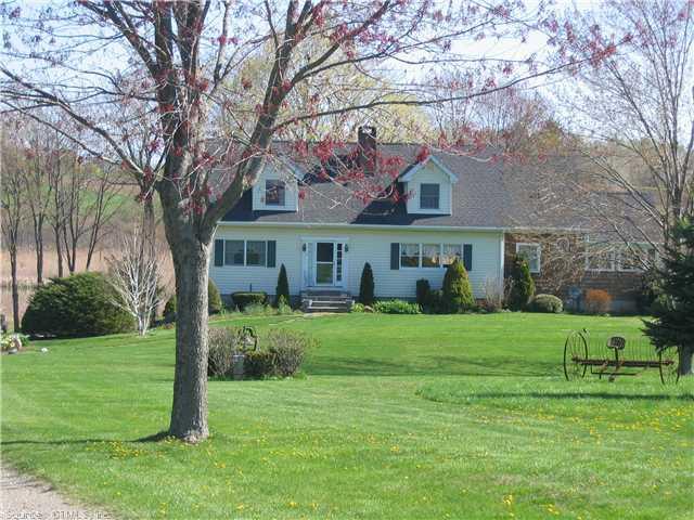 26 Boland Road Sharon, CT 06069 - Photo 1 of 1 a front view of a house with a yard and trees