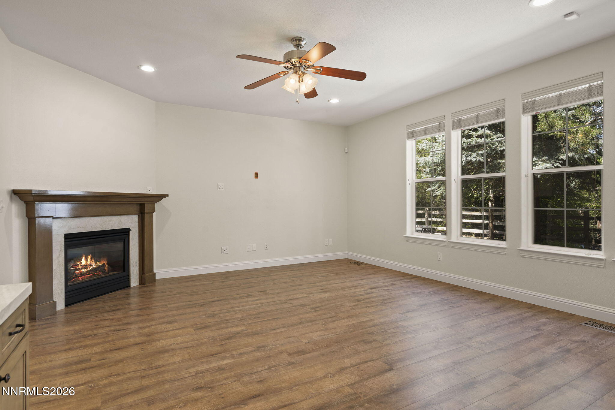 4885 Buckhaven Road Reno, NV 89519 - Photo 21 of 58 a view of an empty room with wooden floor and a window