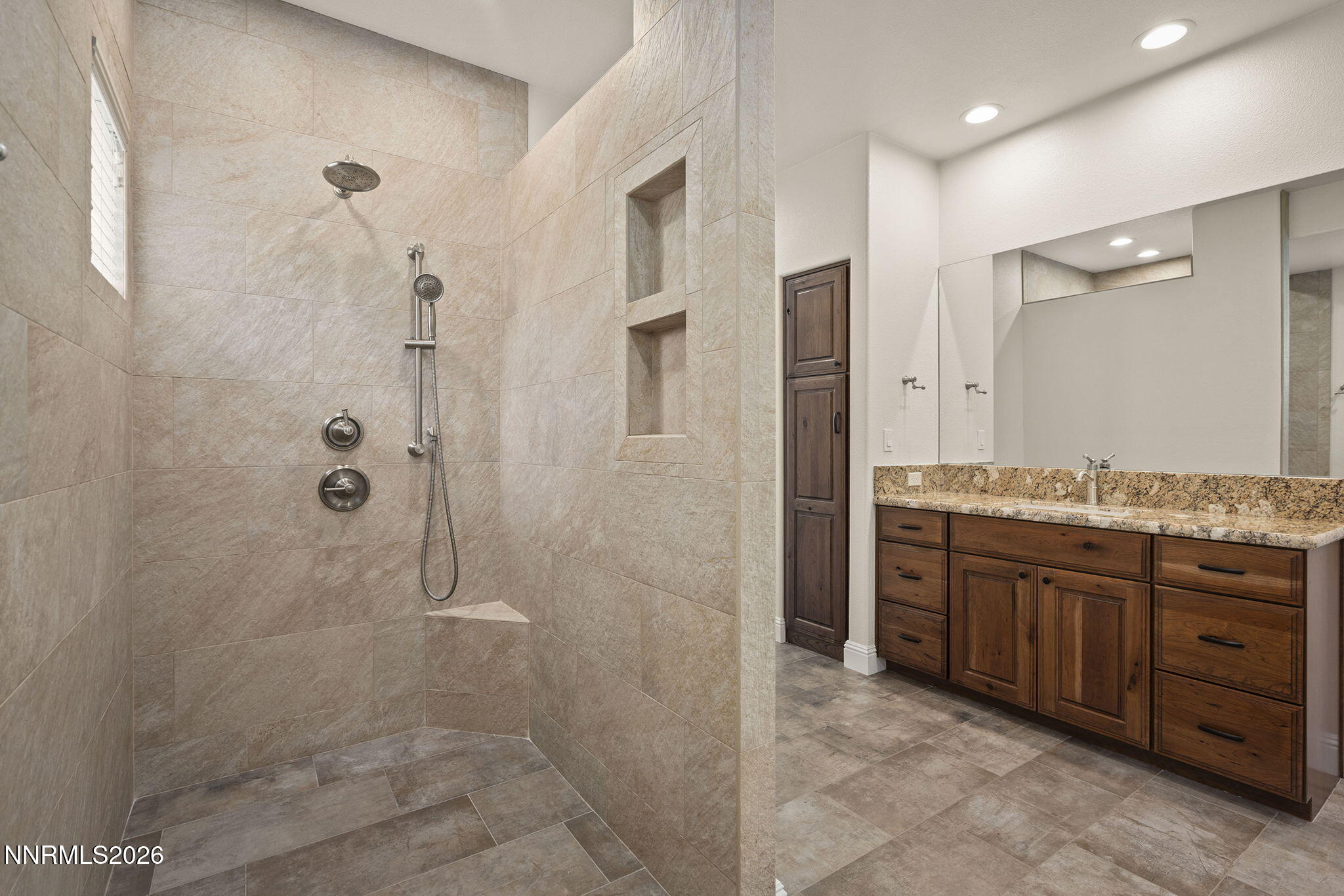 4885 Buckhaven Road Reno, NV 89519 - Photo 31 of 58 a bathroom with a granite countertop sink a mirror and a shower