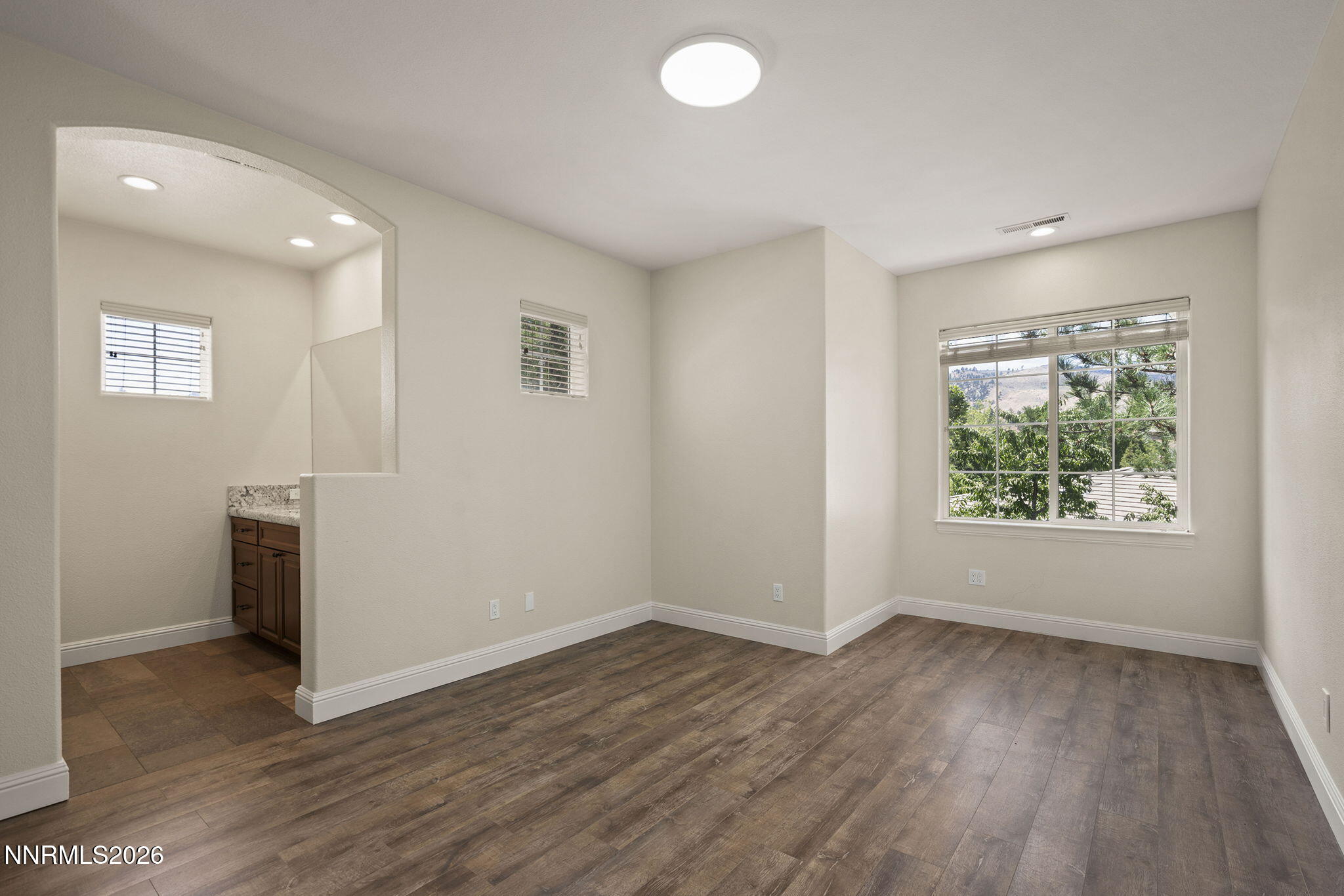 4885 Buckhaven Road Reno, NV 89519 - Photo 38 of 58 an empty room with wooden floor and windows