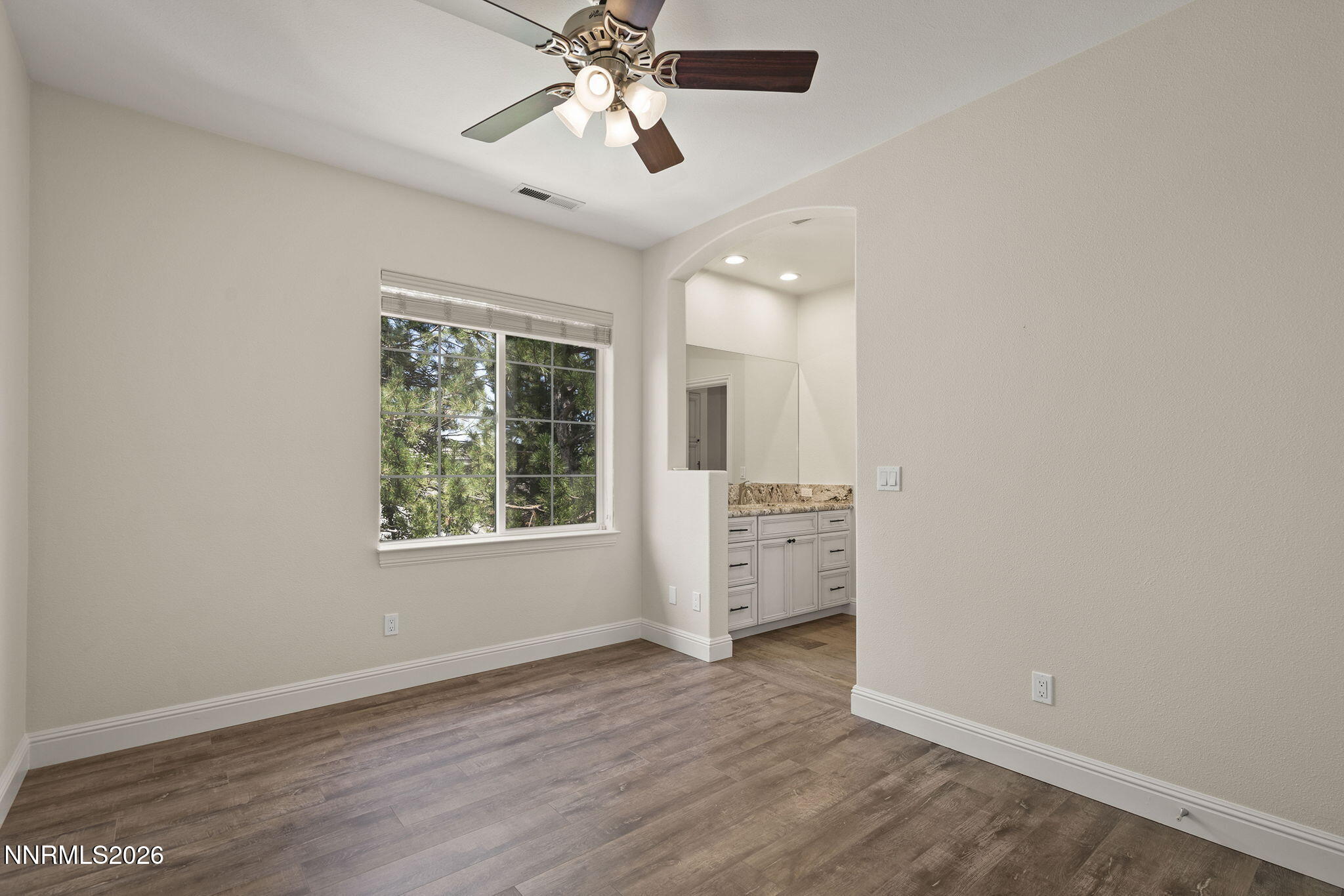 4885 Buckhaven Road Reno, NV 89519 - Photo 40 of 58 an empty room with wooden floor chandelier fan and windows