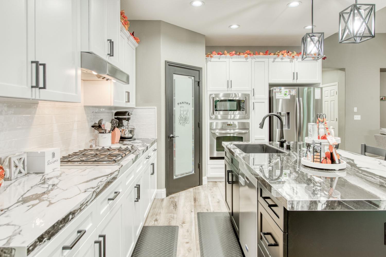 3334 Bellaire Avenue Clovis, CA 93619 - Photo 15 of 54 a kitchen with granite countertop a sink stove and cabinets