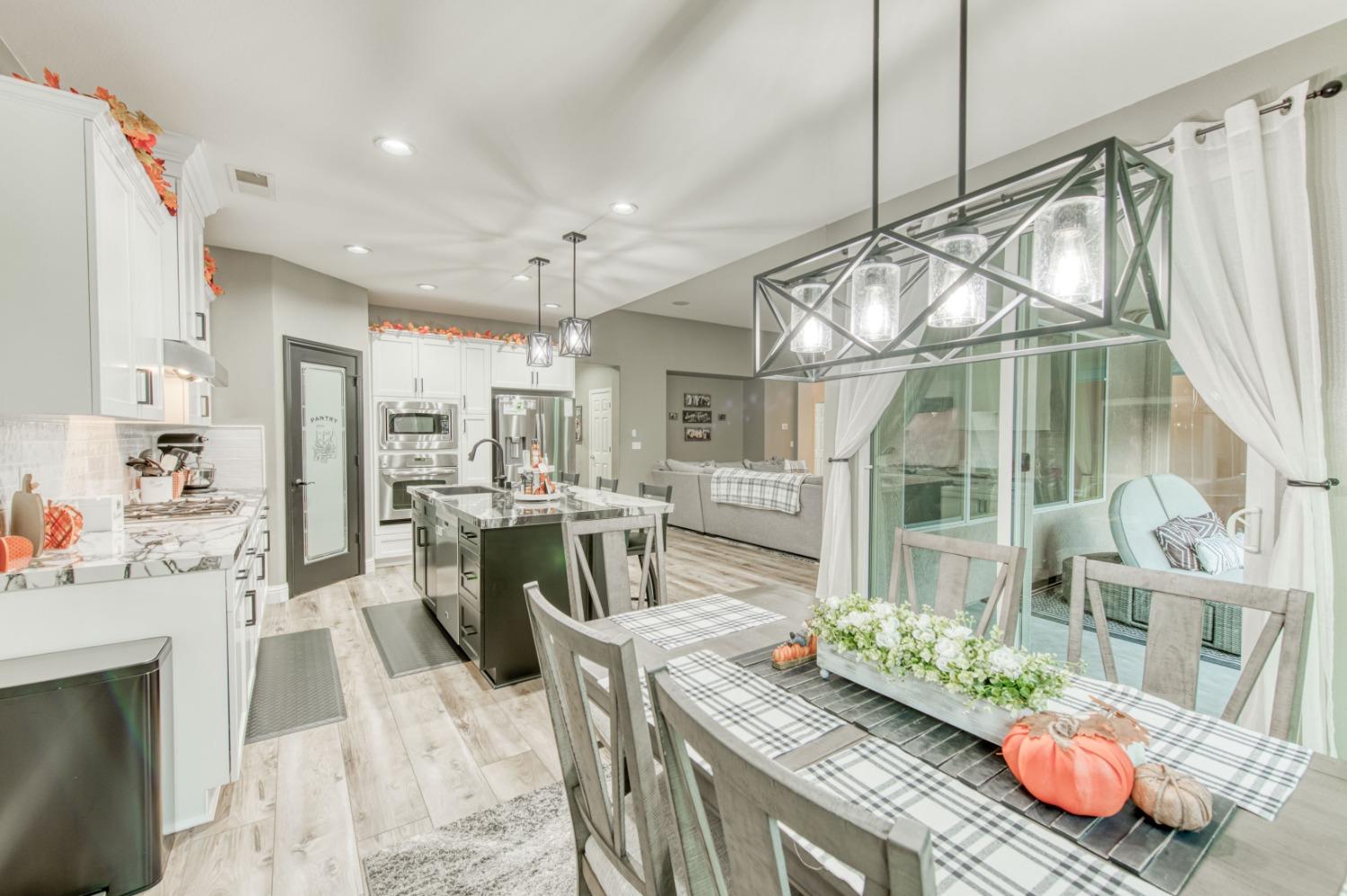 3334 Bellaire Avenue Clovis, CA 93619 - Photo 19 of 54 a living room with lots of furniture and a chandelier