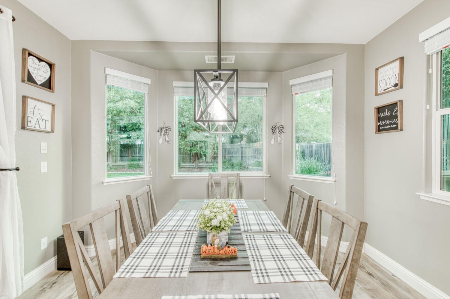3334 Bellaire Avenue Clovis, CA 93619 - Photo 21 of 54 a view of a dining room with furniture wooden floor and windows
