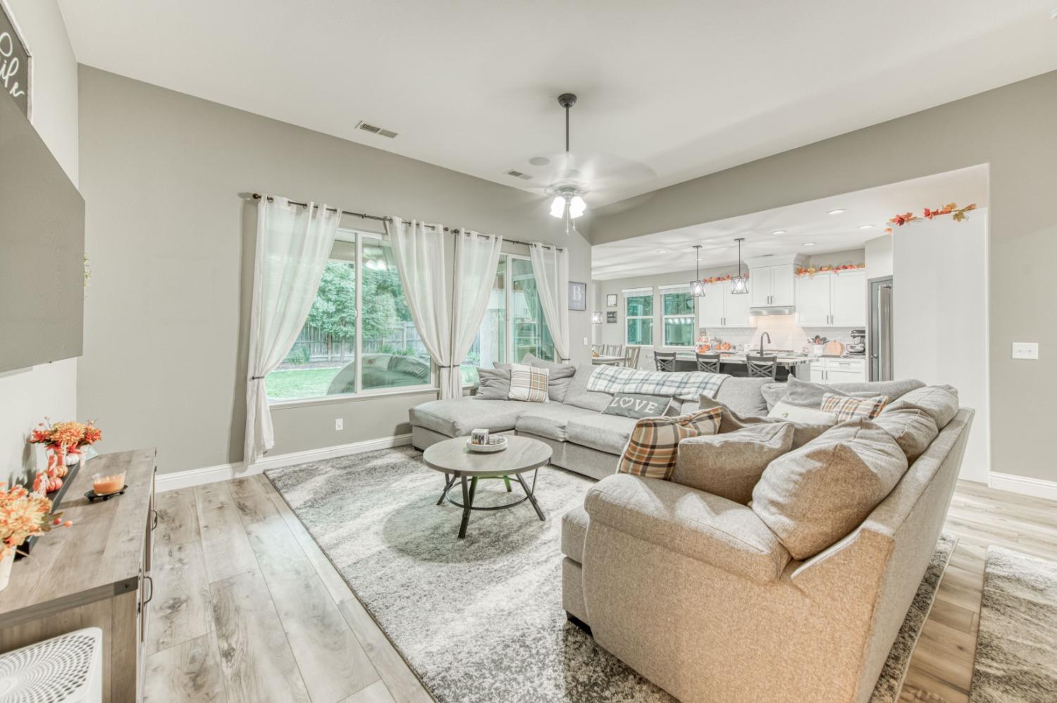 3334 Bellaire Avenue Clovis, CA 93619 - Photo 23 of 54 a living room with furniture and a chandelier